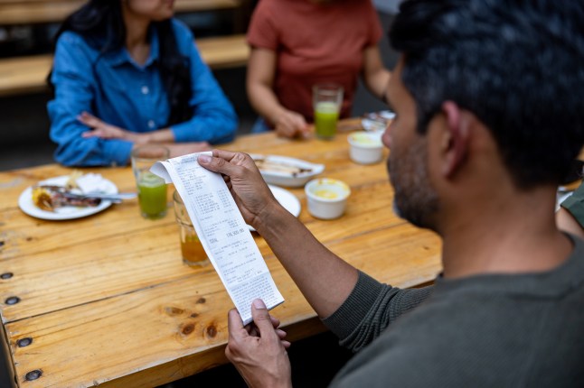 Man checking the bill before paying at a restaurant